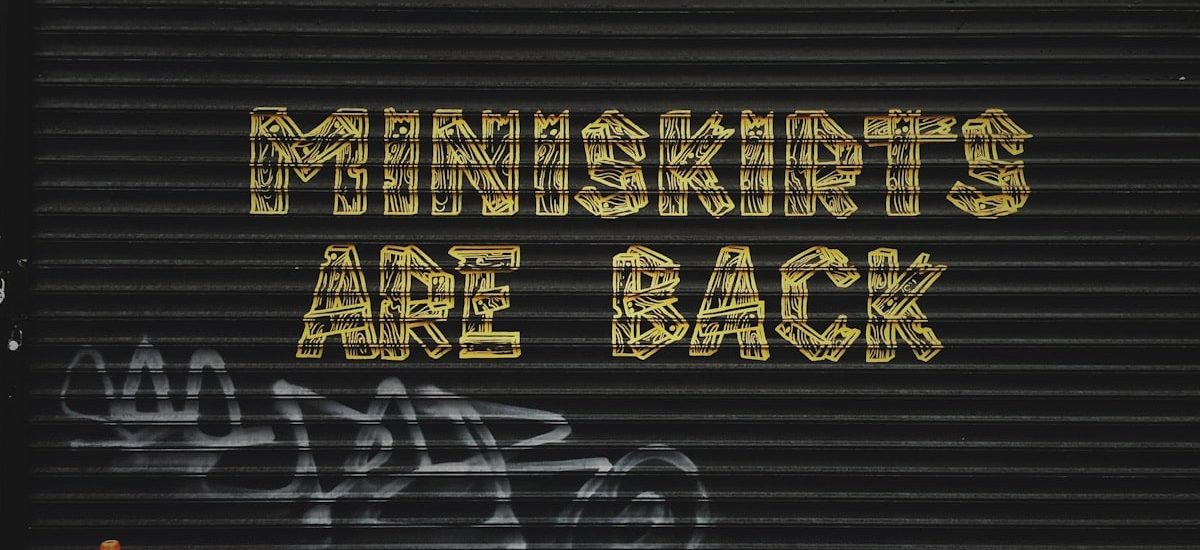 gray background with miniskirts are back text overlay